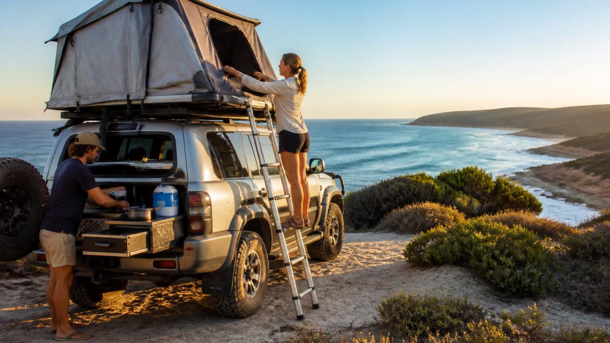 A couple setting up a roof-top tent on a 4WD campervan to book 4WD campervan adventures at a coastal campsite.